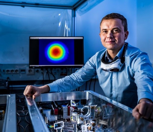 Ultrafast laser technology. From experimental setup for dark matter detection to a commercial product.