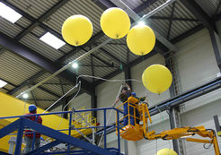 Helium-filled balloons were enlisted to levitate the sensitive superconductors carefully into the hall.