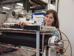 Dr. Eve Stenson at the particle trap, now surrounded by a magnet (black).