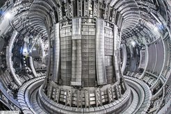 View into the plasma vessel of the European JET fusion device. The metallic coating of the vessel wall with tiles made of beryllium and – at the bottom, in the so-called divertor – of tungsten corresponds to the materials intended for the international experimental reactor ITER.