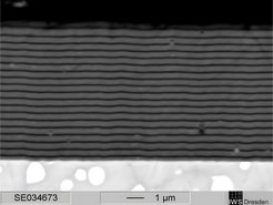 This scanning electron microscope image shows a cross section with multilayer coating combining titanium nitride (TiN) and chromium nitride (CrN), designed to prevent tritium loss in future fusion reactors.